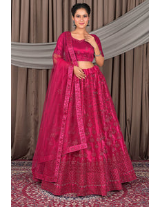 Woman wearing a traditional pink saree with a matching blouse