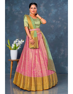 Woman in a traditional outfit with a pink and green lehenga choli