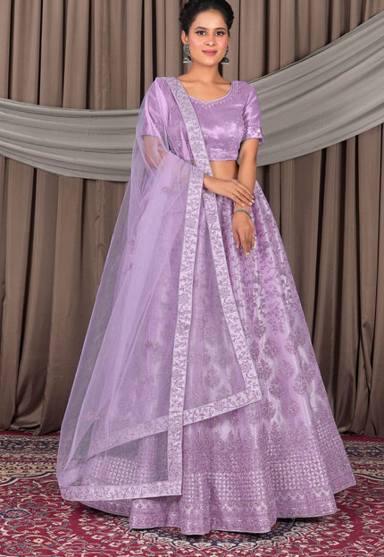 Woman wearing a lavender traditional outfit with a matching dupatta