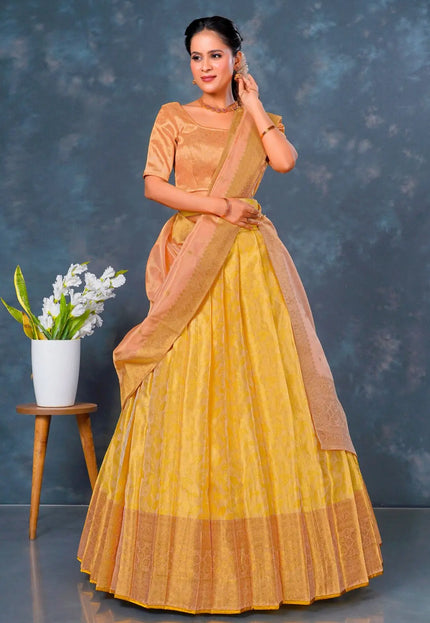 Woman wearing a yellow lehenga choli with dupatta