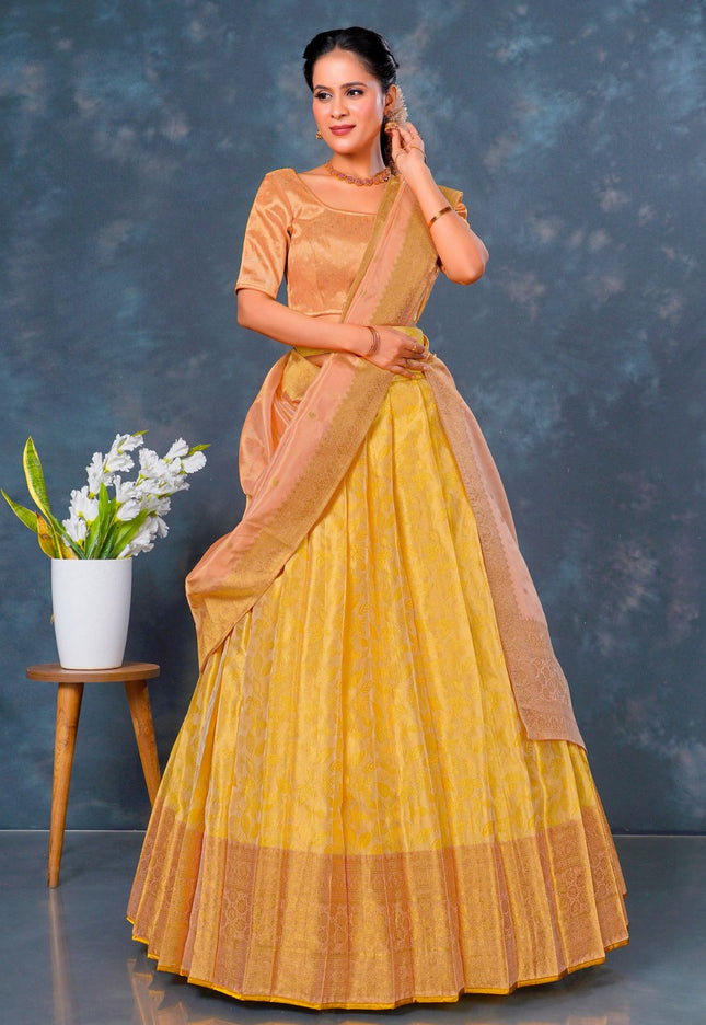 Woman wearing a yellow lehenga choli with dupatta