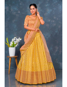 Woman wearing a yellow lehenga choli with dupatta