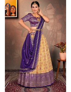 Woman in a traditional purple and lemon lehenga choli with dupatta