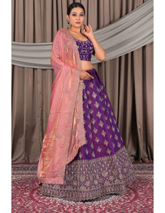 Woman wearing a traditional purple and pink lehenga choli with dupatta