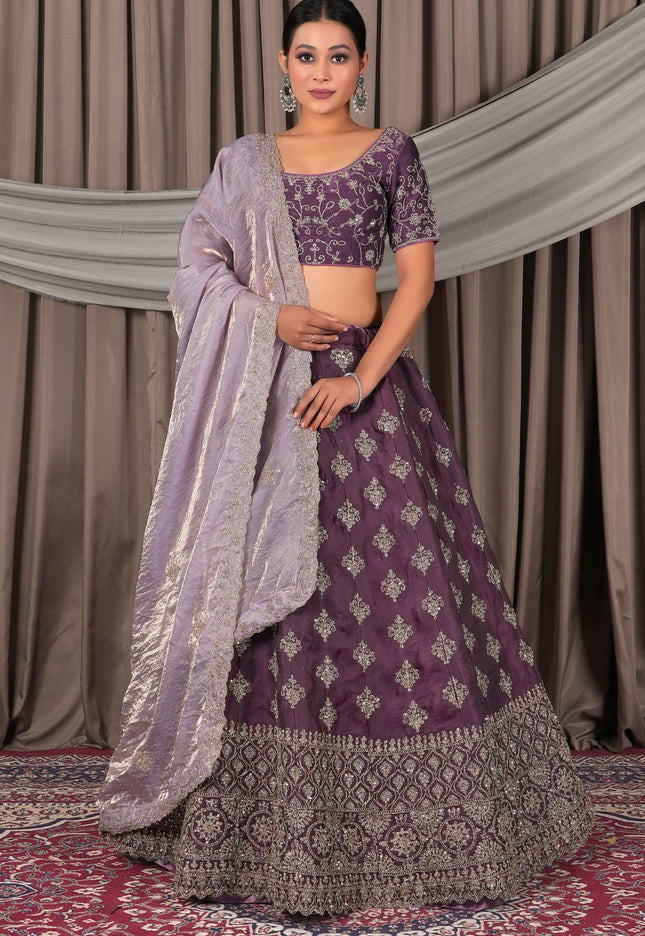 Woman wearing a traditional purple lehenga with a matching blouse
