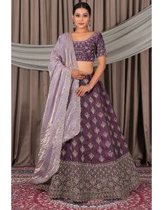 Woman wearing a traditional purple lehenga with a matching blouse