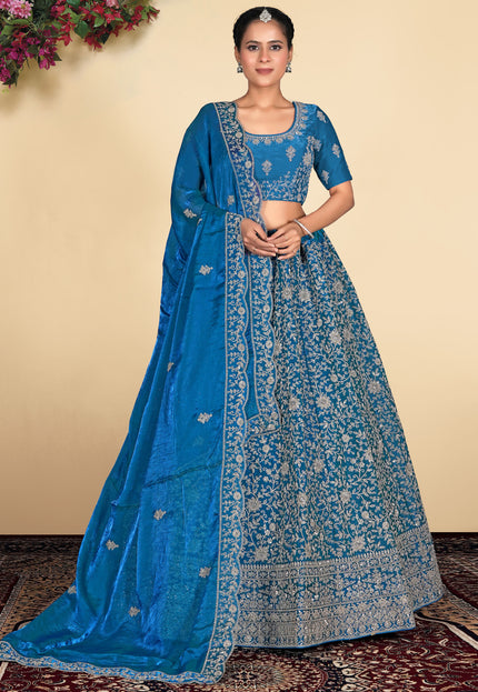 Woman wearing a blue embroidered lehenga choli