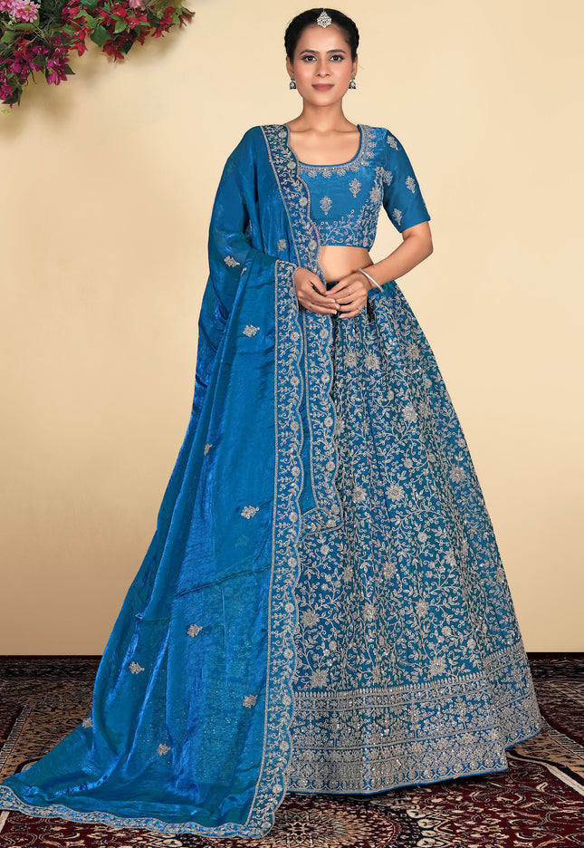 Woman wearing a blue embroidered lehenga choli