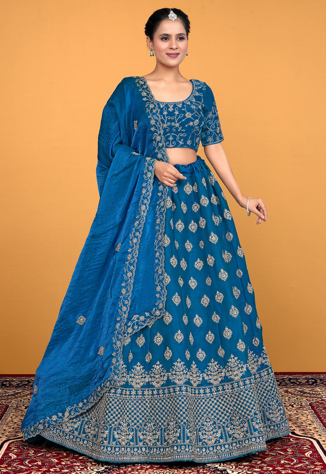 Woman wearing a blue embroidered traditional lehenga choli