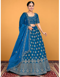Woman wearing a blue embroidered traditional lehenga choli