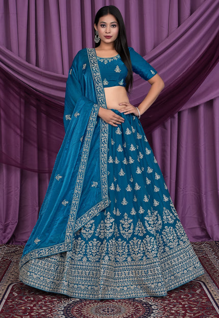 Woman wearing a blue embroidered traditional lehenga choli