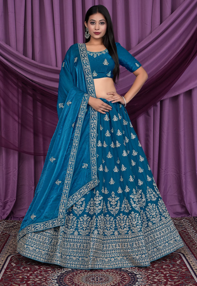 Woman wearing a blue embroidered traditional lehenga choli