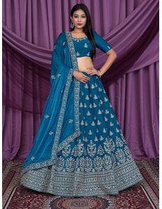 Woman wearing a blue embroidered traditional lehenga choli