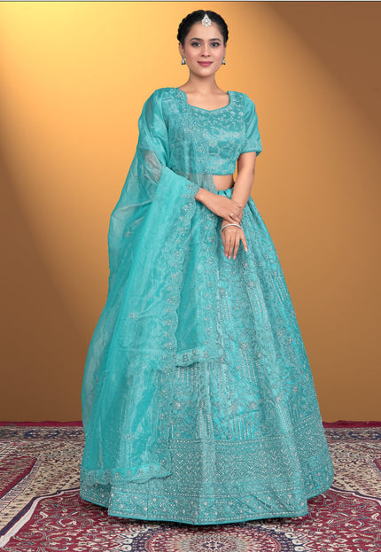 Woman wearing a turquoise embroidered lehenga choli