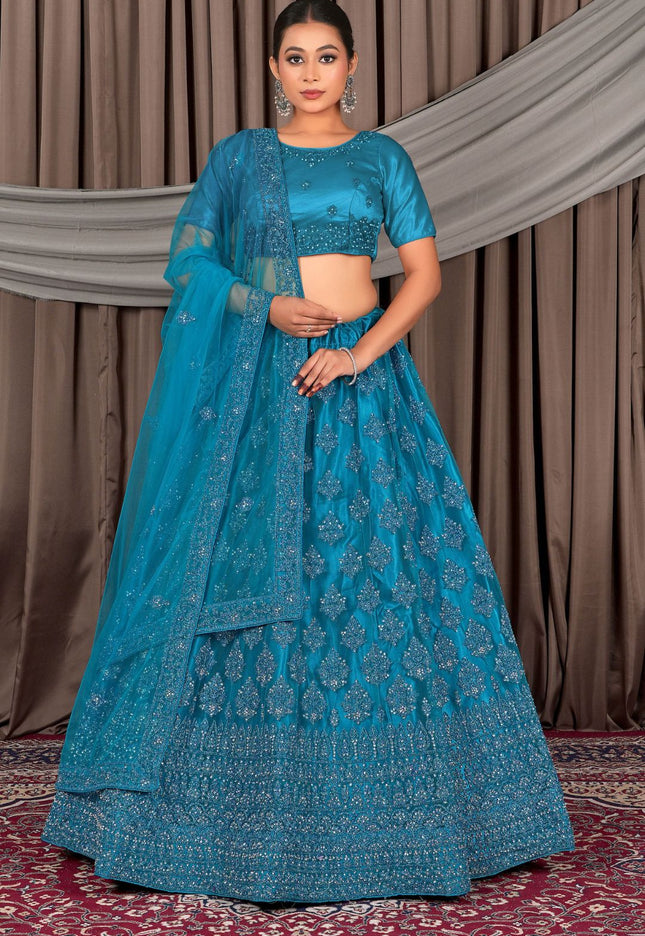 Woman wearing a blue traditional outfit with a matching dupatta
