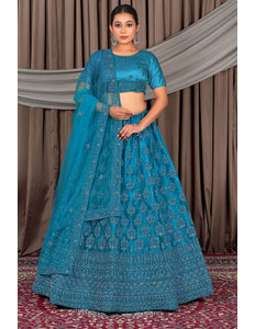 Woman wearing a blue traditional outfit with a matching dupatta