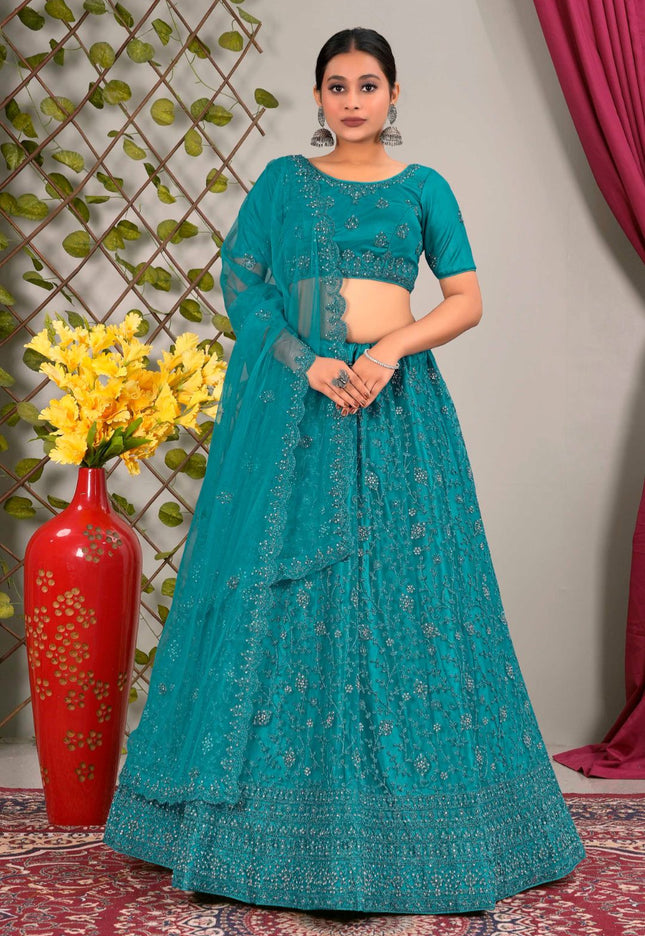 Woman in a teal traditional lehenga choli with matching dupatta