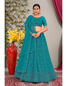 Woman in a teal traditional lehenga choli with matching dupatta