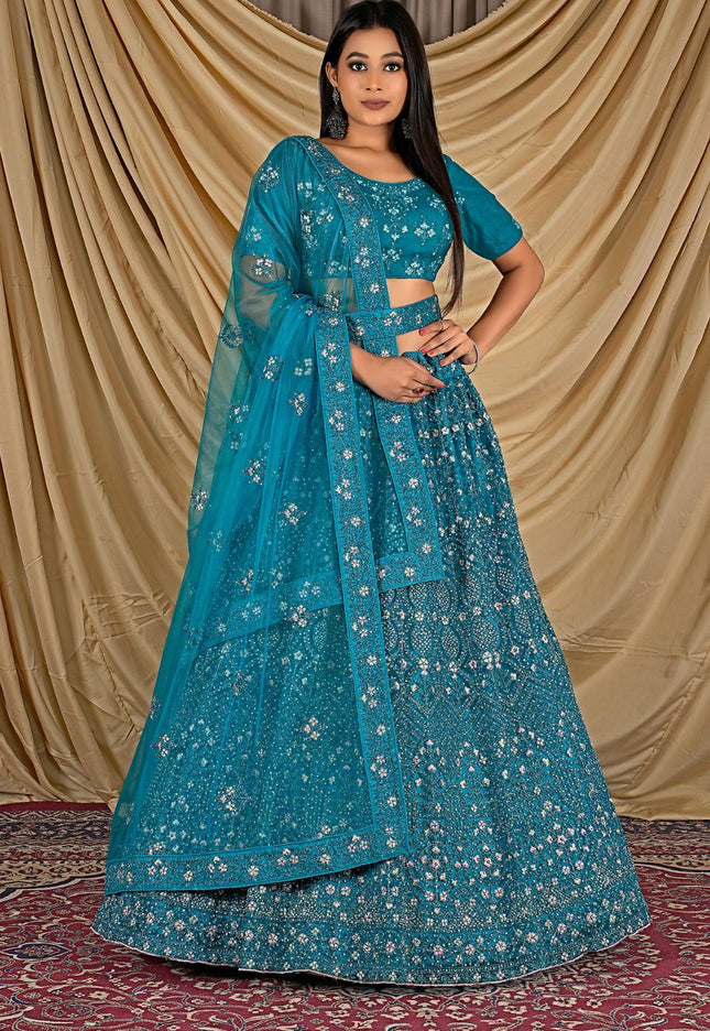 Woman wearing a blue embroidered traditional lehenga choli with dupatta