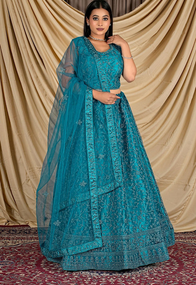Woman wearing a teal embroidered outfit with a matching dupatta