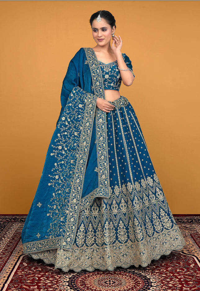 Woman wearing a blue embroidered traditional lehenga choli
