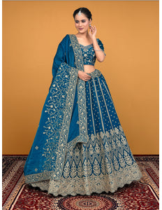 Woman wearing a blue embroidered traditional lehenga choli