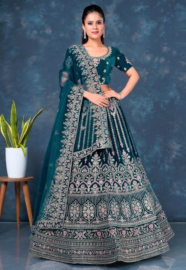 Woman wearing a traditional embroidered outfit with a blue and green color