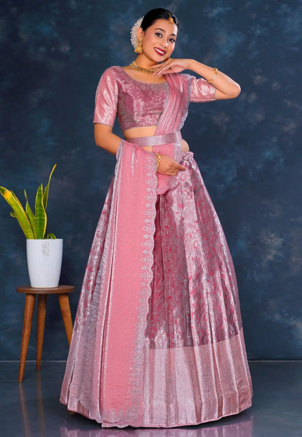 Woman in a pink traditional lehenga choli with dupatta