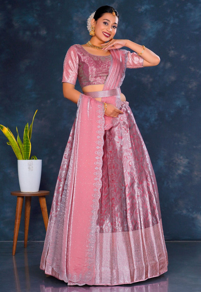 Woman in a pink traditional lehenga choli with dupatta