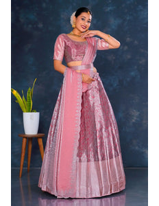 Woman in a pink traditional lehenga choli with dupatta