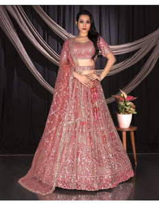 Woman in a pink embroidered traditional outfit
