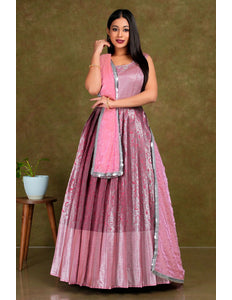 Woman in a pink and purple traditional outfit with a matching dupatta