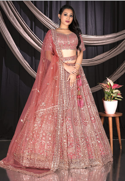 Woman in a traditional pink and gold embroidered outfit