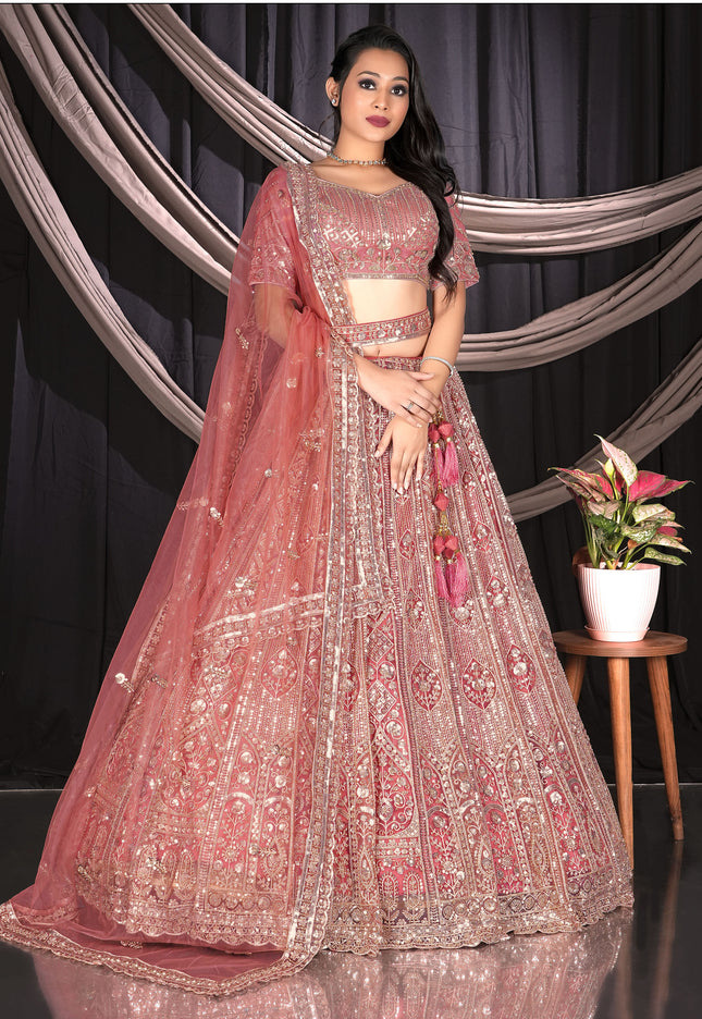 Woman in a traditional pink and gold embroidered outfit