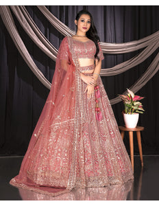 Woman in a traditional pink and gold embroidered outfit