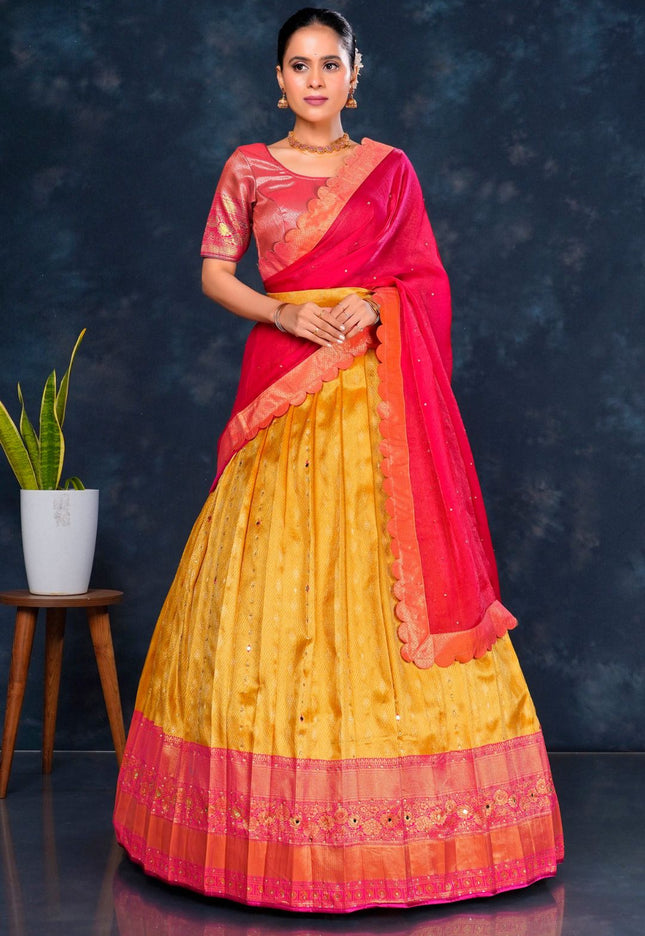 Woman wearing a gold and pink Half Saree with dupatta