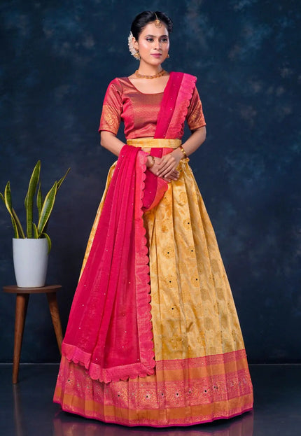 Woman wearing a traditional outfit with a pink and gold lehenga choli with dupatta