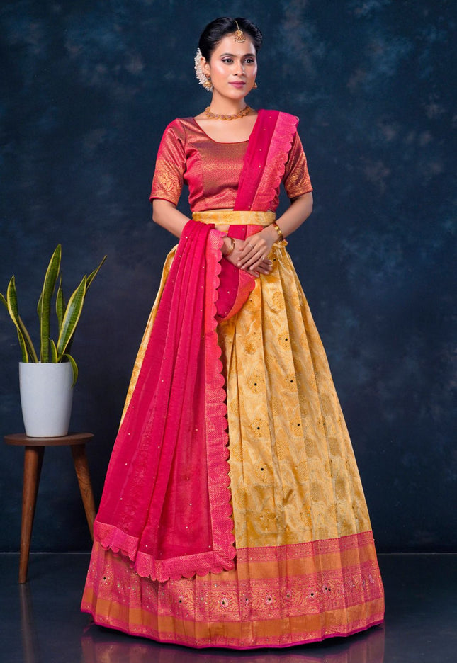 Woman wearing a traditional outfit with a pink and gold lehenga choli with dupatta
