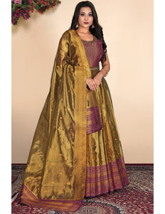 Woman wearing a traditional gold and purple gown with dupatta