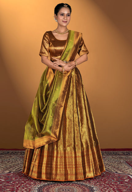 Woman wearing a traditional gold and green lehenga choli