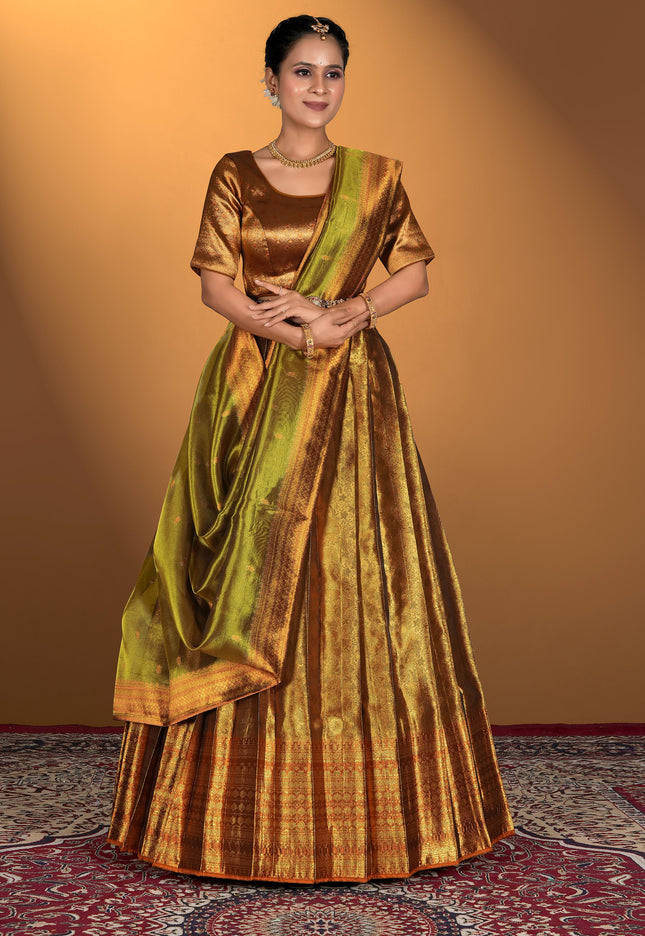 Woman wearing a traditional gold and green lehenga choli