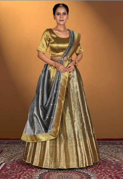 Woman wearing a traditional gold and gray lehenga
