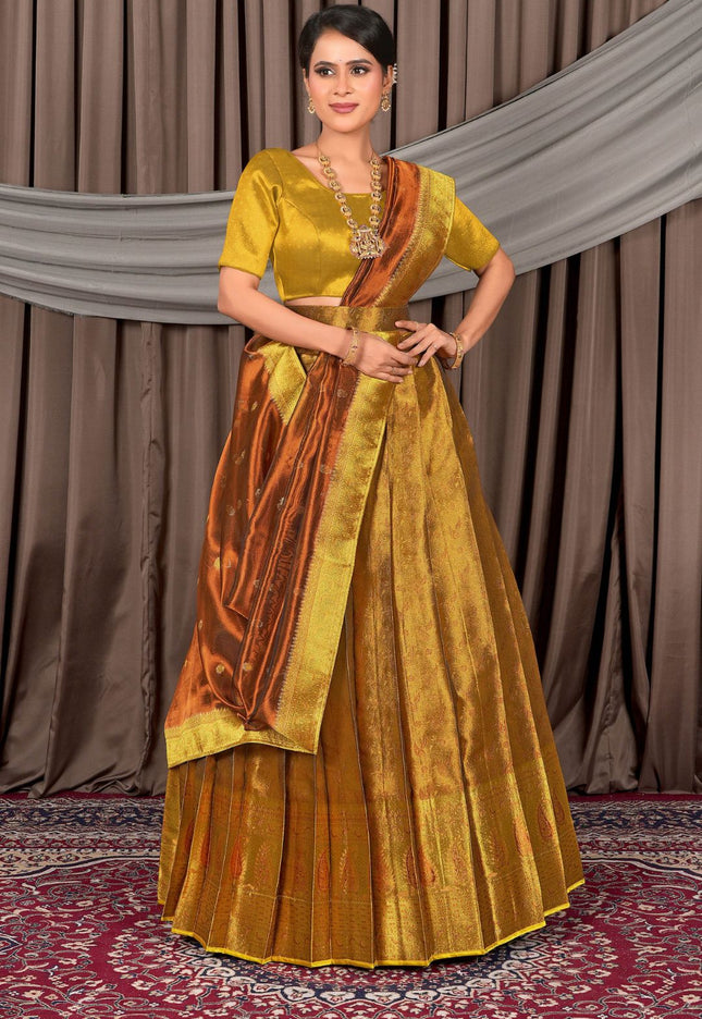 Woman wearing a traditional yellow and orange lehenga with a matching blouse