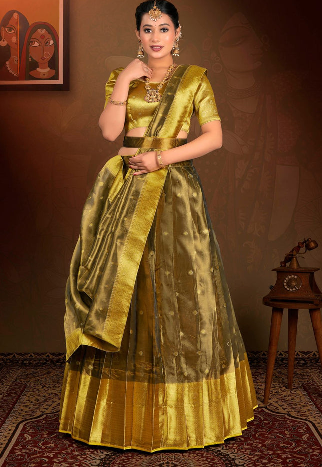 Woman in a traditional gold lehenga choli with dupatta