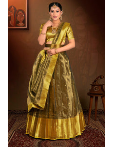 Woman in a traditional gold lehenga choli with dupatta