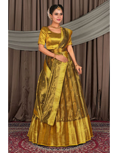 Woman wearing a gold lehenga with a matching blouse