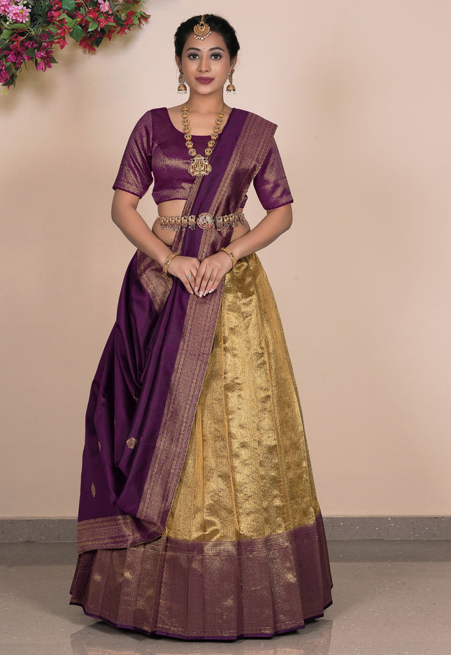 Woman wearing a traditional purple and gold lehenga choli