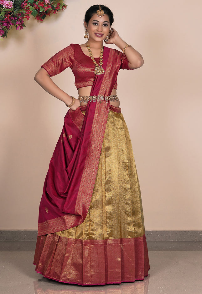 Woman wearing a traditional maroon and gold lehenga choli