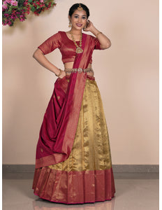 Woman wearing a traditional maroon and gold lehenga choli