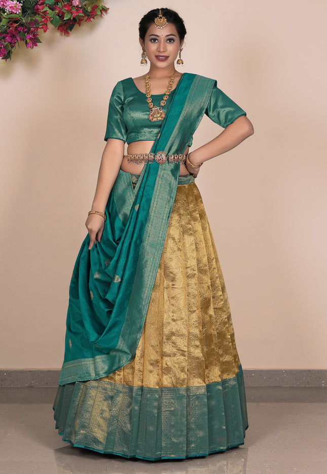 Woman wearing a traditional green and gold lehenga choli